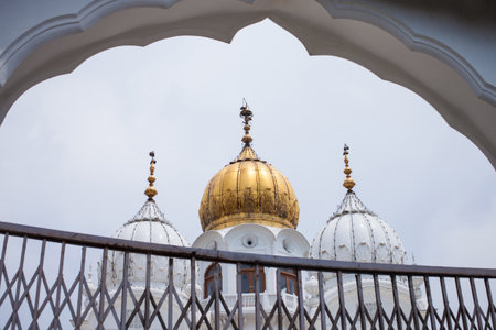 White and golden domes of mosques against the cloudy sky backgroundの写真素材