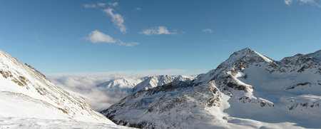 Sunny mountains peaks in winter Alps.の写真素材