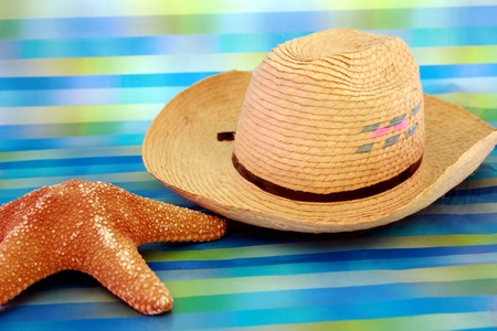 beach straw hat and a starfish on turquoise backgroundの写真素材