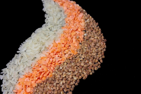 rice, buckwheat, red lentils, isolated on a black backgroundの写真素材