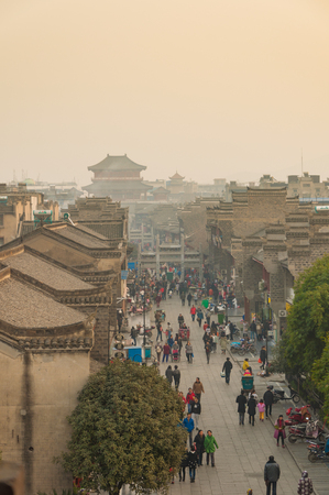 XIANGYANG, CHINA - December 18, 2016 : people and shops on walk street in evening at XiangYang city wall, Chinaのeditorial素材