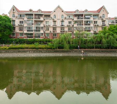 Shanghai, China - May 20, 2017 : housing and park by canalのeditorial素材