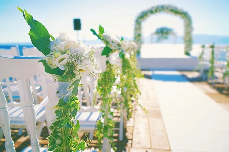 Wedding ceremony place at the port, chairs decorated with flowers.の写真素材