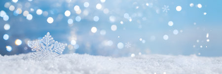 Sparkling snowflake decoration on a bed of fresh white snow with a festive blue bokeh background, perfect for winter holidaysの素材