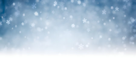 Beautiful winter background with falling snow and a soft blue gradient, featuring a clean white area for design elementsの素材