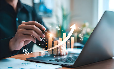 Businessman analyzing financial data on laptop, displaying growth chart with percentage increase, symbolizing successful investment strategy and market progressの素材