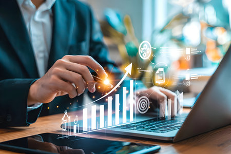Business professional analyzes market data on laptop with glowing digital overlay, illustrating financial growth, strategic planning and investment success.の素材