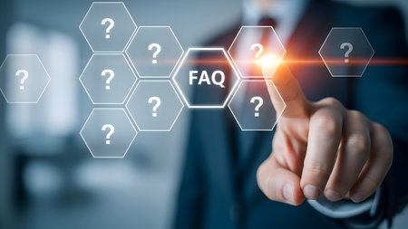 Hand of a businessman pointing to a glowing faq hexagon on a virtual screen surrounded by question mark icons for frequently asked questions and help.の素材