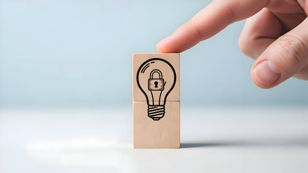 Safeguarding innovative ideas, intellectual property, and creative concepts with a locked lightbulb icon on stacked wooden blocks, security.の素材