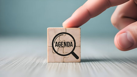 Agenda on cube. hand. planning, strategy, prioritization. business meeting management, project goals, time efficiency for success.の素材