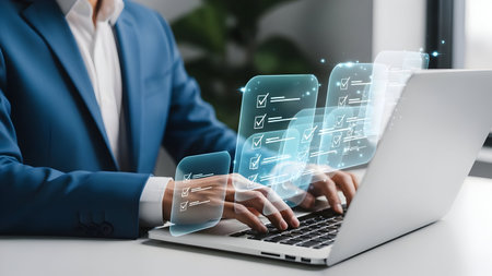Businesswoman analyzing data visualization projected from a laptop during a modern office meetingの素材