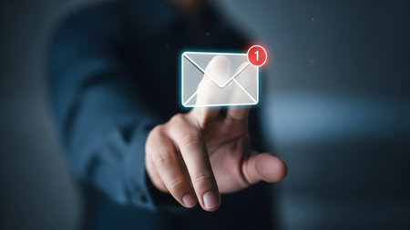 A person interacting with a glowing digital envelope notification representing email or secure messagingの素材
