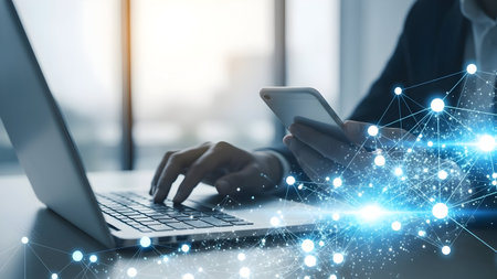 Hands typing on a laptop keyboard with a digital data stream overlay representing network connectivityの素材