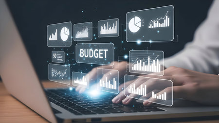 Financial planning concept with a person using a laptop displaying data charts and budget informationの素材