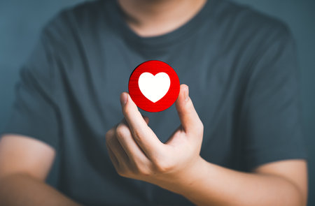 Hand of customer picking Love button on Social media. The concept of Social media and digital...