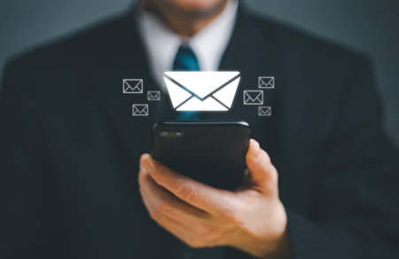 Businessman hand using mobile smart phone with virtual screen newsletter for electronic mail,...