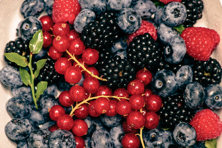 Wild berries background. Blueberry, raspberries, blackberry. Background of berries. Summer berries...