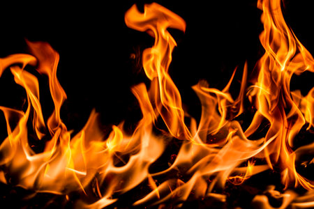 Fire flame background. Hell bonfire. Texture of fire on a black background. Blaze flames background...