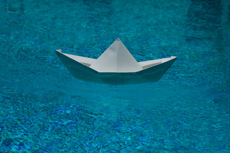 Sail boat. Tourism and traveling. Travel dreams vacation holiday. Sailing adventure. Traveling adventure. Summertime vacation. Paper ship and ocean water. Paper boat in water. Paper boat sailing.の写真素材
