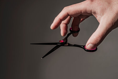 Barbershop background. Man holding scissors.の写真素材