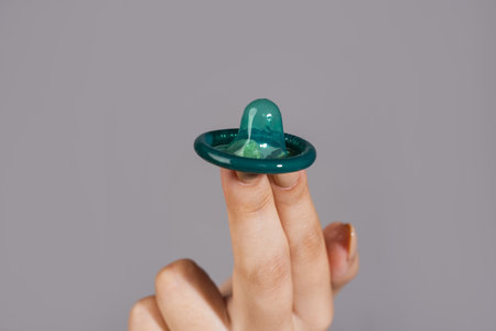 Condom in hand. Condom contraception. Safe sex concept. Rubber latex condoms for safe sex.の写真素材