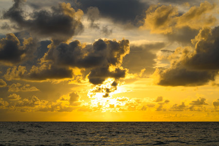 Dramatic sky and sun rays. Stormy cloud sky. Clouds above ocean. Dark cloudy sky at sunset background. Cloud sky with sea background.の写真素材