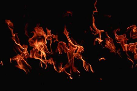 Fire over black background. Fire sparks background. Abstract blaze flames background. Burning fire....