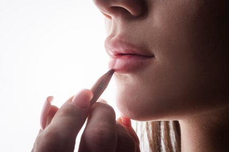 Woman lipstick makeup closeup. Beautiful female with pink lips. Lips background. Woman applying...