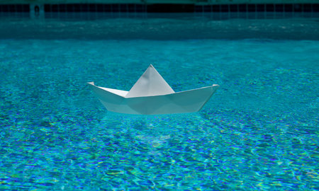 Paper boat in water. Paper boat sailing. Sail boat. Tourism and traveling, travel dreams vacation holiday, sailing adventure. Traveling adventure. Summertime vacation. Paper ship and ocean water.の写真素材