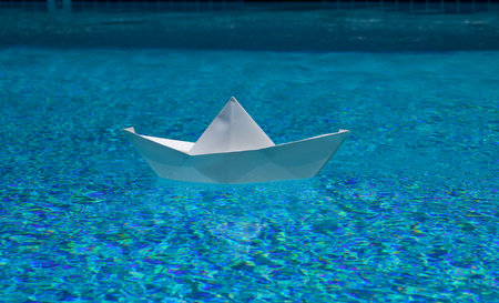 Sailing adventure. Sail boat. Tourism and traveling. Travel dreams vacation holiday. Traveling adventure. Summertime vacation. Paper ship and ocean water. Paper boat in water. Paper boat sailing.の写真素材
