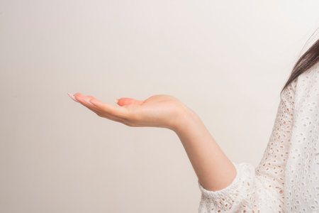 Women hand on white background. In hand. In hands. Product in hands. Woman hand holding something. Open female hand holding something.の写真素材
