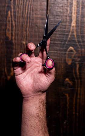 Barbershop background. Mans haircut in barber shop. Vintage barbershop background. Man holding scissors. Barber scissors, barbershop. Barber scissors barbershop.の写真素材