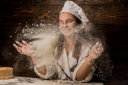 Baking concept. Prepares pastry. Dough on wooden table. Bakery background. Dough. Making dough. Girl...