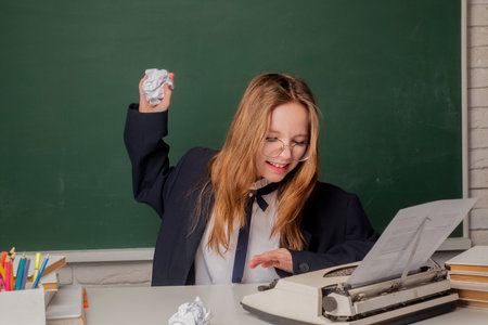 Elementary kid at classroom. Angry schoolkid. Schoolkid or preschooler learn. Portrait of schoolgirl...