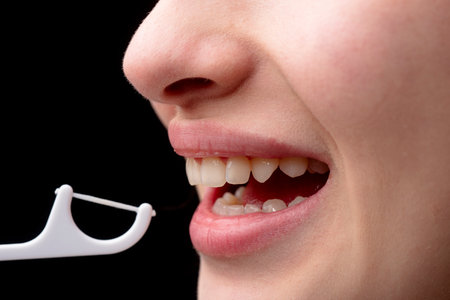 Dental clinic. Dental and stomatology concept. Dental hygiene and oral health care concept. Brushing teeth using plastic toothpick with dental floss. Concept of hygiene and oral cavity.の写真素材