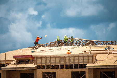 Wooden roof. Roofs repair. Construction site. Roofer worker at roof. Top roof. Big roof beams. Constructed stick house. Building. Build background.の写真素材