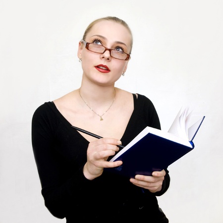 a girl at work thinks and looks upの写真素材