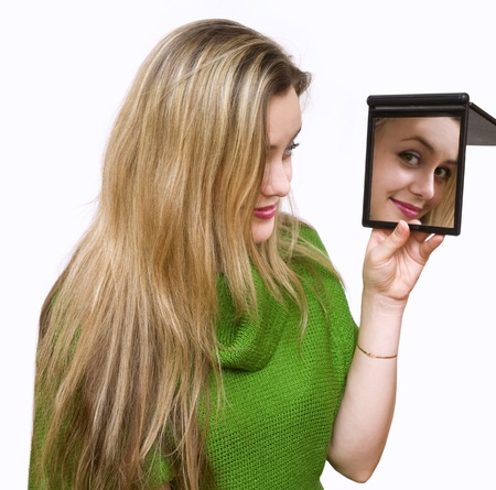 a girl in green looks in a mirrorの写真素材