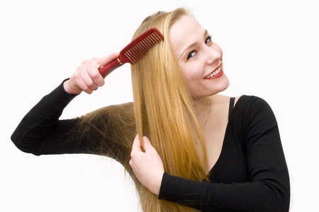 young girl smiling combs hairの写真素材