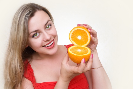 Portrait of young and attractive girl with  orangeの写真素材