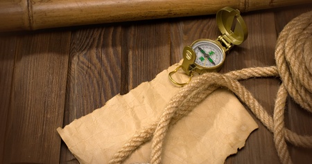 old compass and rope on the background of old weathered woodの写真素材