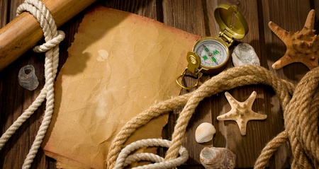 old compass and rope on the background of old weathered woodの写真素材