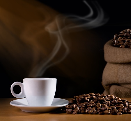 Coffee cup with burlap sack of roasted beansの写真素材