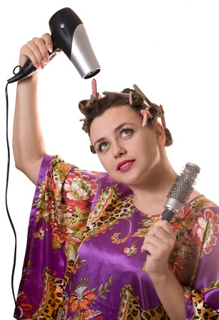 Beautiful woman drying her hair with hairdryerの写真素材