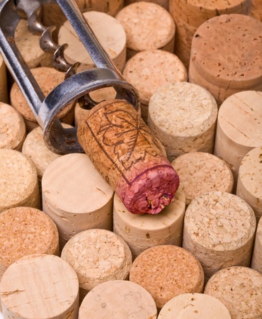 corkscrew with a cork on the background of corksの写真素材