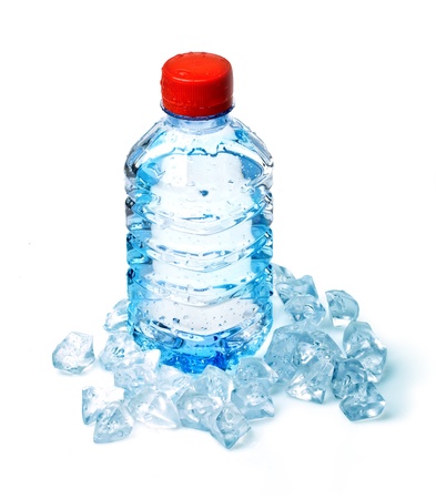 Bottle of water in ice cubes on white backgroundの写真素材