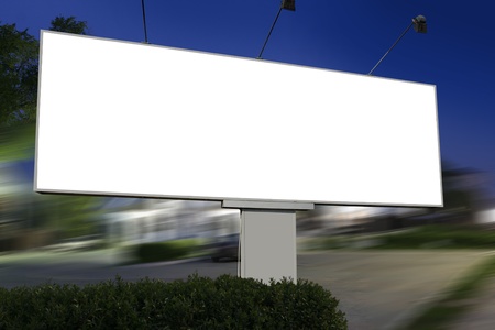 white display advertising with traffic at nightの写真素材