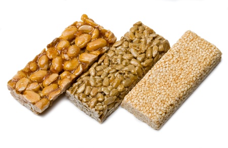 sunflower seeds, sesame ,peanuts in sugar syrup isolated on a white backgroundの写真素材