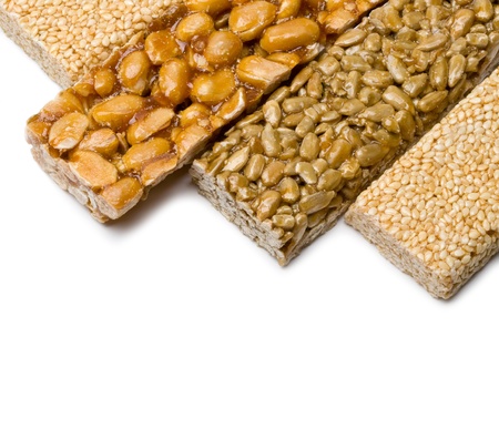 sunflower seeds, sesame ,peanuts in sugar syrup isolated on a white backgroundの写真素材