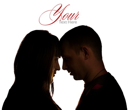 Silhouette of young man and woman in loveの写真素材